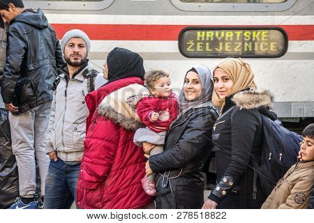 Sid, Serbia - November 14, 2015: Refugees, A Family With Children And Women With Islamic Scarf, Boar