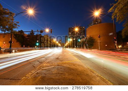 Cars Light Trails On A Straight Road At Night. Running Parallel Side By Side. Night Traffic Trails. 
