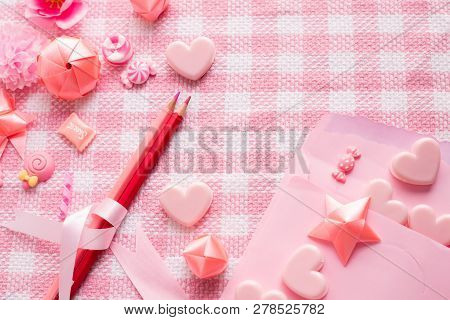 Letter Love And Valentine's Day Decoration On Pink Tablecloth Texture Background.