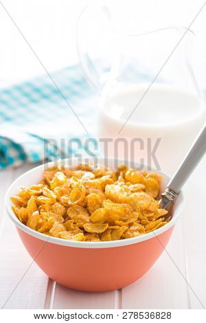 Breakfast cereals or cornflakes in bowl on white background.