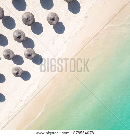 Aerial View Of Amazing Tropical White Sandy Beach With Palm Leaves Umbrellas And Turquoise Sea.