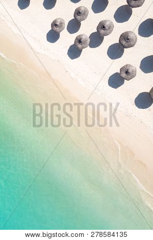 Aerial View Of Amazing Tropical White Sandy Beach With Palm Leaves Umbrellas And Turquoise Sea.