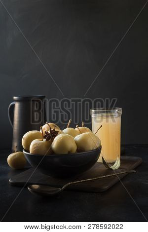 Pickled Apples In Bowl And Apple Sidr On Dark Stone Table.