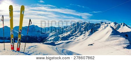 Ski in winter season, mountains and ski touring backcountry equipments on the top of snowy mountains in sunny day, Verbier Switzerland.