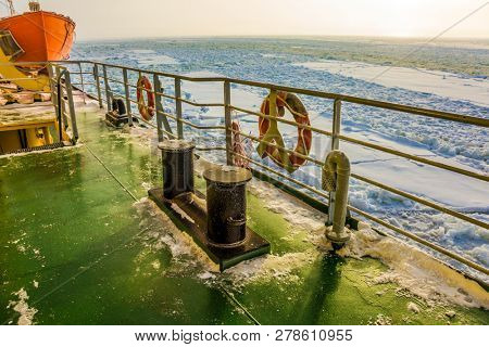  Lapland. The excursion to the arctic tourist cruise on the sea icebound. The strip of ice crumb spreads behind the icebreaker. The concept of active and extreme tourism