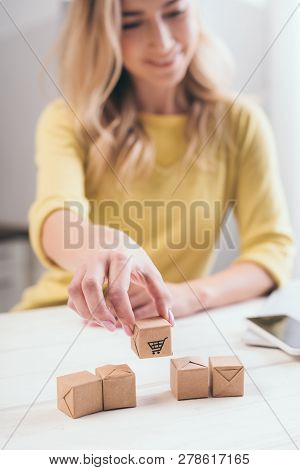 Selectie Focus Of Small Paper Boxes With Blonde Woman On Background