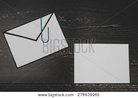 Funny Metaphor Of Inbox With Email Envelop And Attachment Clip On Real-life Desk