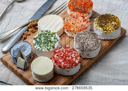 Assortment Of French Fresh White Soft Goat Cheeses With Different Tastes Topping Made With Herbs, Pa