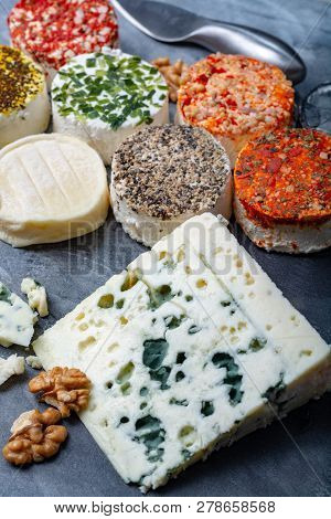 Assortment Of French Fresh White Soft Goat Cheeses With Different Tastes Topping Made With Herbs, Pa