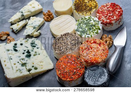 Assortment Of French Fresh White Soft Goat Cheeses With Different Tastes Topping Made With Herbs, Pa