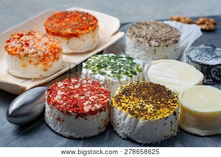 Assortment Of French Fresh White Soft Goat Cheeses With Different Tastes Topping Made With Herbs, Pa