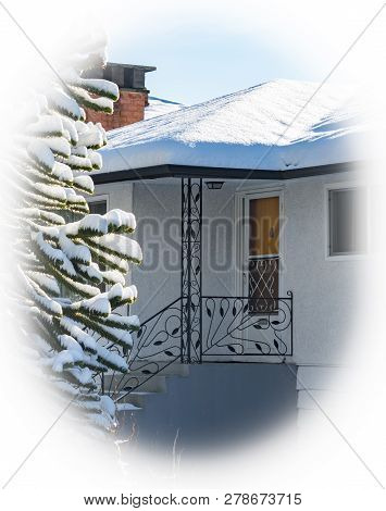 Entrance Of Residential House With Monkey Tree In Front. Family House In Snow On Winter Season