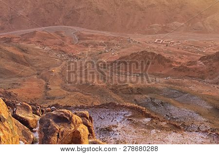 Pilgrimage Place And Famous Touristic Destination. Aerial View Of Small Village At The Foot Of Mount