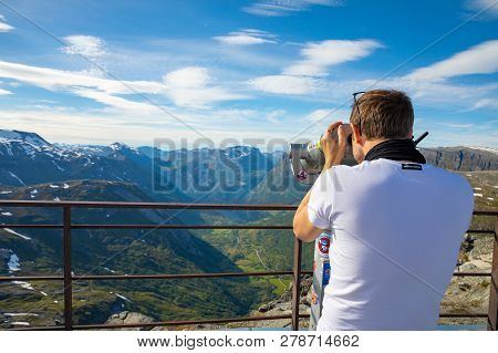 Dalsnibba, Norway - 26.06.2018: Man Looking In Binoculars On View Point Dalsnibba, View Of Gejranger