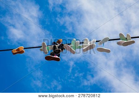 Prague, Czech Republic - April, 2018: Shoes Hanged At The Power Lines Next To The Metronome At The L