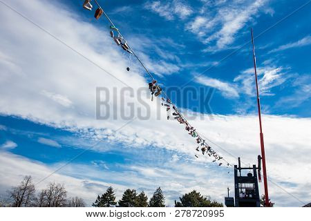 Prague, Czech Republic - April, 2018: Shoes Hanged At The Power Lines Next To The Metronome At The L
