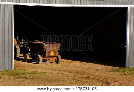 A Grain Wagon Loaded With Shelled Corn Displaying A Smv  Vehicle Sign Is Parked In A Huge Metal Quon