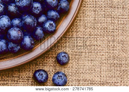 Tasty Juicy Blueberry In A Clay Plate On A Brown Napkin