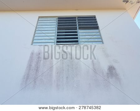 Storm Window With Dirt On Wall Of House In Puerto Rico