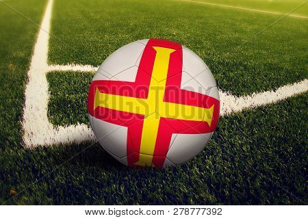 Guernsey Ball On Corner Kick Position, Soccer Field Background. National Football Theme On Green Gra