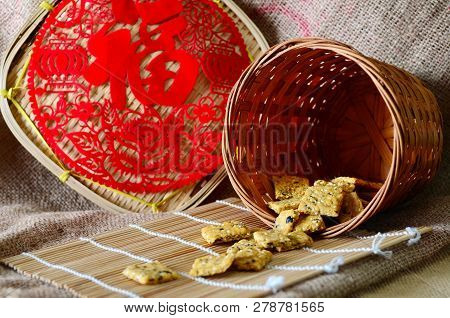 Chinese New Year Homemade Cookies With Sesame Seeds, On Bamboo Stick , On Sackcloth Background
