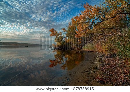 Beautiful Autumn Landscape With Calm River. Fall Nature - Colorful Trees And Blue Sky With Clouds Re