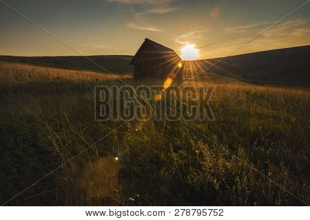 Sunset In Countryside Landscape. Fields And Countryside Landscape. Old Cabin In Nature In Sunset. Na