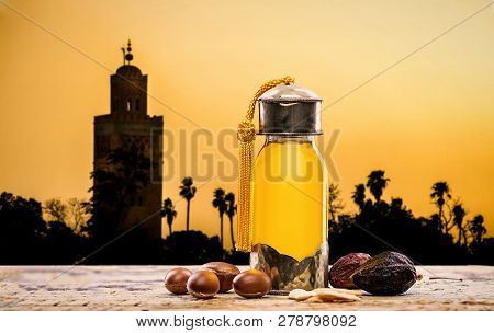 Bottle Of Argan Oil And Fruits For Skin Care With Moroccan Landscape On The Background