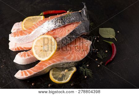 Raw Salmon Fish Fillet On Black Background
