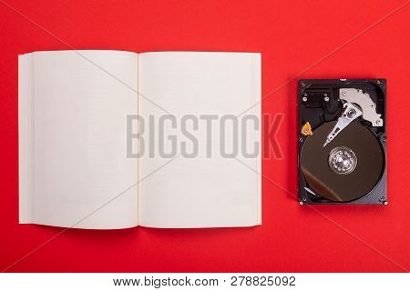 Noteboook And Cassette Isolated On Red Background