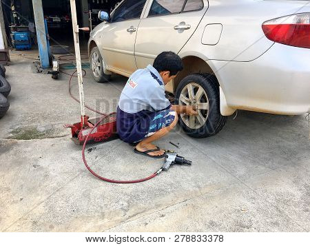Photo Of An Old Are Parks In The Garage Waiting For Change A New Tyre In Local Garage Of Thailand Co