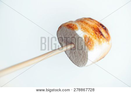 Roasted Marshmallows On A Skewer On White Background