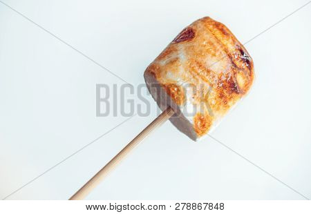 Roasted Marshmallows On A Skewer On White Background