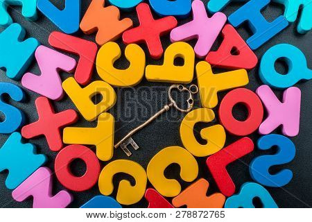 Retro Key And Colorful Letters Of Alphabet Made Of Wood