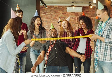 Colleagues Having Party After Work In Office Playing Limbo
