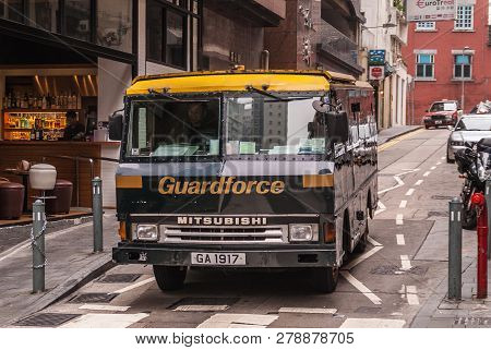 Hong Kong Island, China  - May 14, 2010: Black, Gold And Yellow Reinforced Money Transport Truck Of 