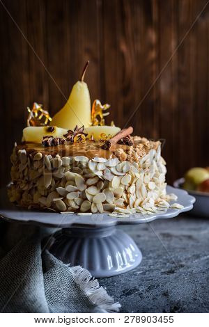 Layered Cake With Caramel Glaze, Decorated With Almond Slices, Pears, Spun Sugar Decorations And Cin