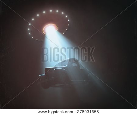 Unidentified Flying Object Lifting A Car. Concept Of Alien Abduction. Old Style Photo With Noise Of 