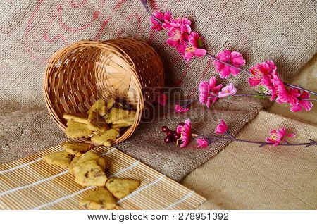 Chinese New Year Homemade Cookies With Sesame Seeds, On Bamboo Stick , On Sackcloth Background