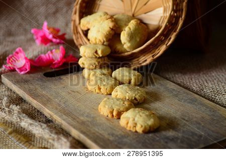 Chinese New Year Homemade Cookies With Beans On Wooden Plate , On Sackcloth Background