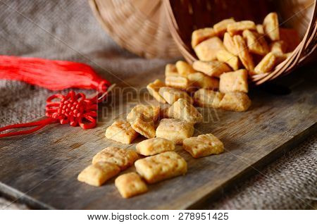 Chinese New Year Homemade Cookies With Cheese On Wooden Plate , On Sackcloth Background