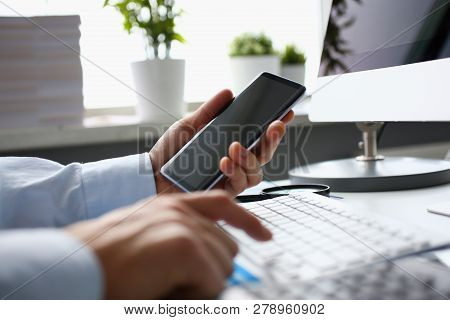Businessman Hipster Holds Telephone Background Of Computer Keyboard In Office Clodeup. Make Transact
