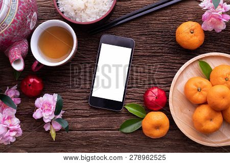 Wood Table With Blank Screen On Smart Phone, Cell Phone, Tablet And Chinese New Year Composition Set