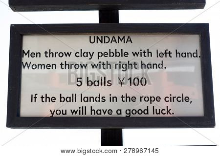 Miyazaki, Japan - November 6, 2018: Sign for a traditional game in front of Udo Shrine to earn good luck