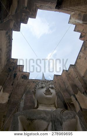 Low Angle View Of The Buddha Statue Of Wat Si Chum In Sukhothai Historical Park