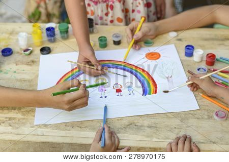 Happy Family Concept. Co-creation. Children Hands Draw On A Sheet Of Paper: Father, Mother, Boy And 