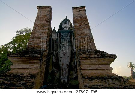 Stading White Buddha Statue In The Sukhothai Historical Park