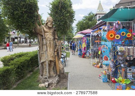 Evpatoria, Crimea, Russia - July 4, 2018: Wooden Figure Of A Bogatyr And Street Trade In Beach Acces