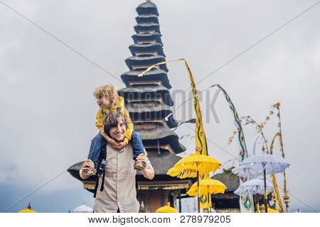 Dad And Son In The Background Of Pura Ulun Danu Bratan, Bali. Hindu Temple Surrounded By Flowers On 