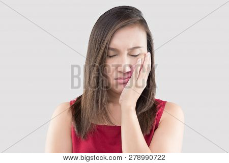 Suffering From A Toothache, Asian Woman Wearing A Red Shirt Suffering From A Toothache While Standin